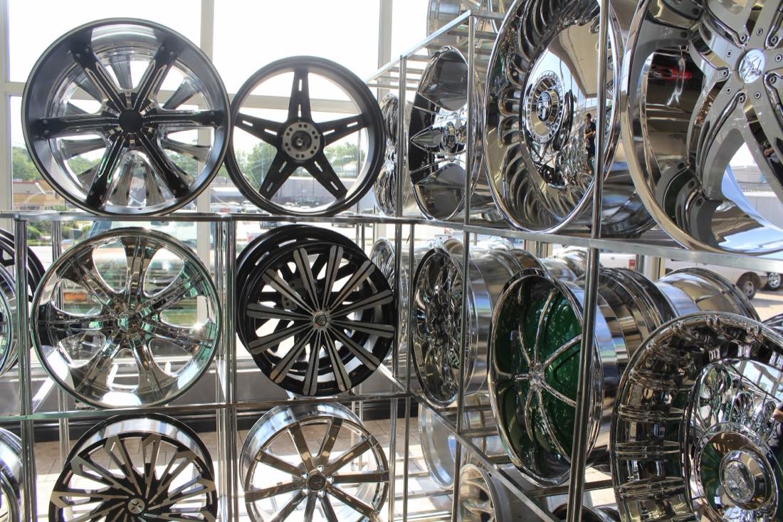 Wall of chrome custom wheels and rims on display at Avo's Tire & Rim