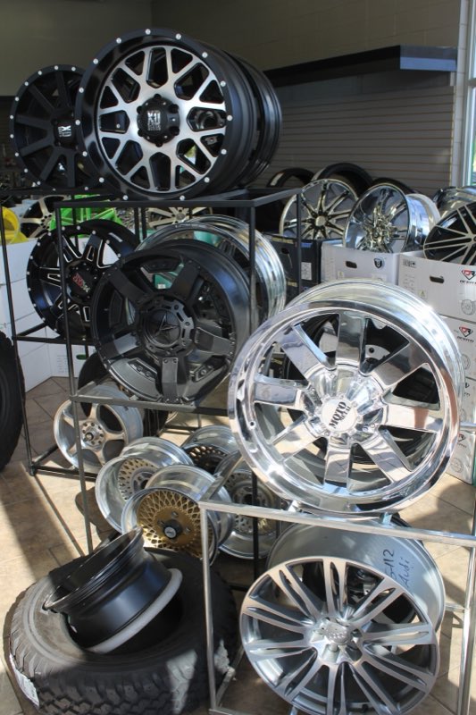Racks of truck and car rims and tires in stock