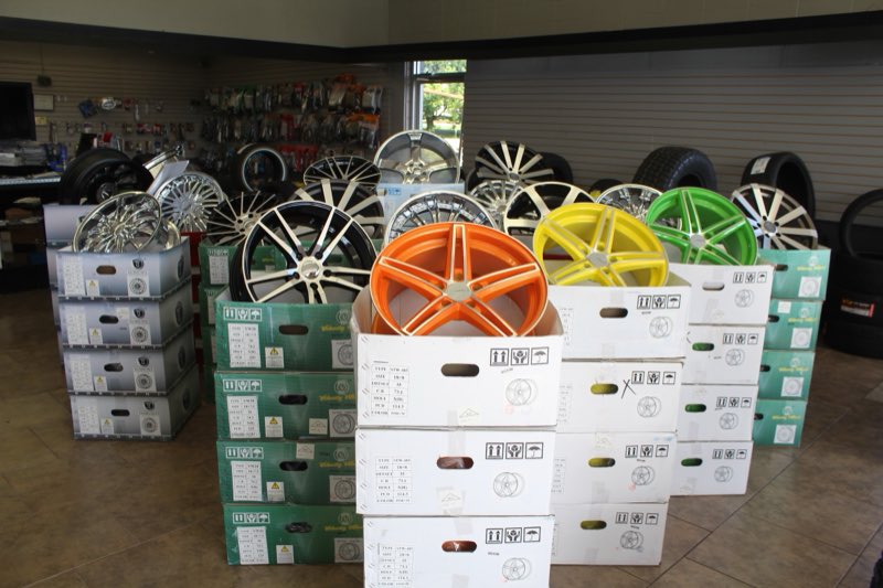 Showroom with orange, yellow and green custom wheels on display
