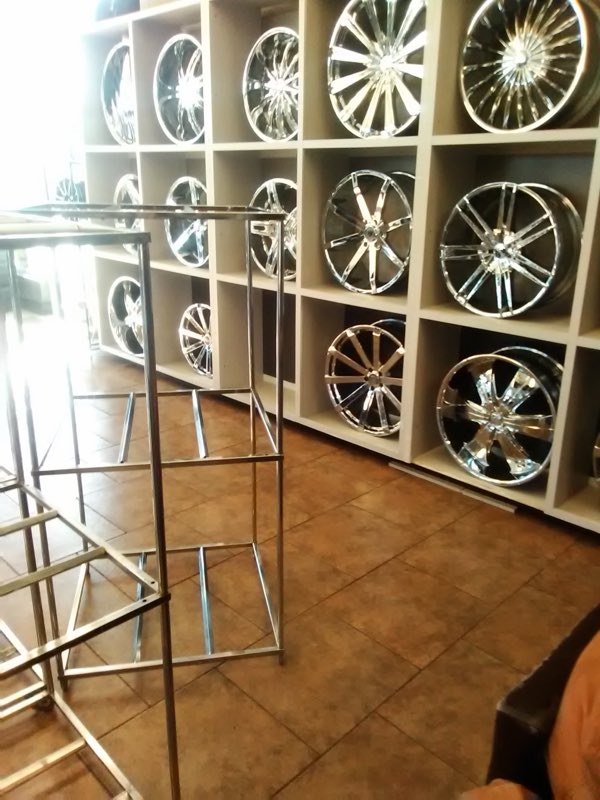 Wall of chrome wheels arranged on a display rack
